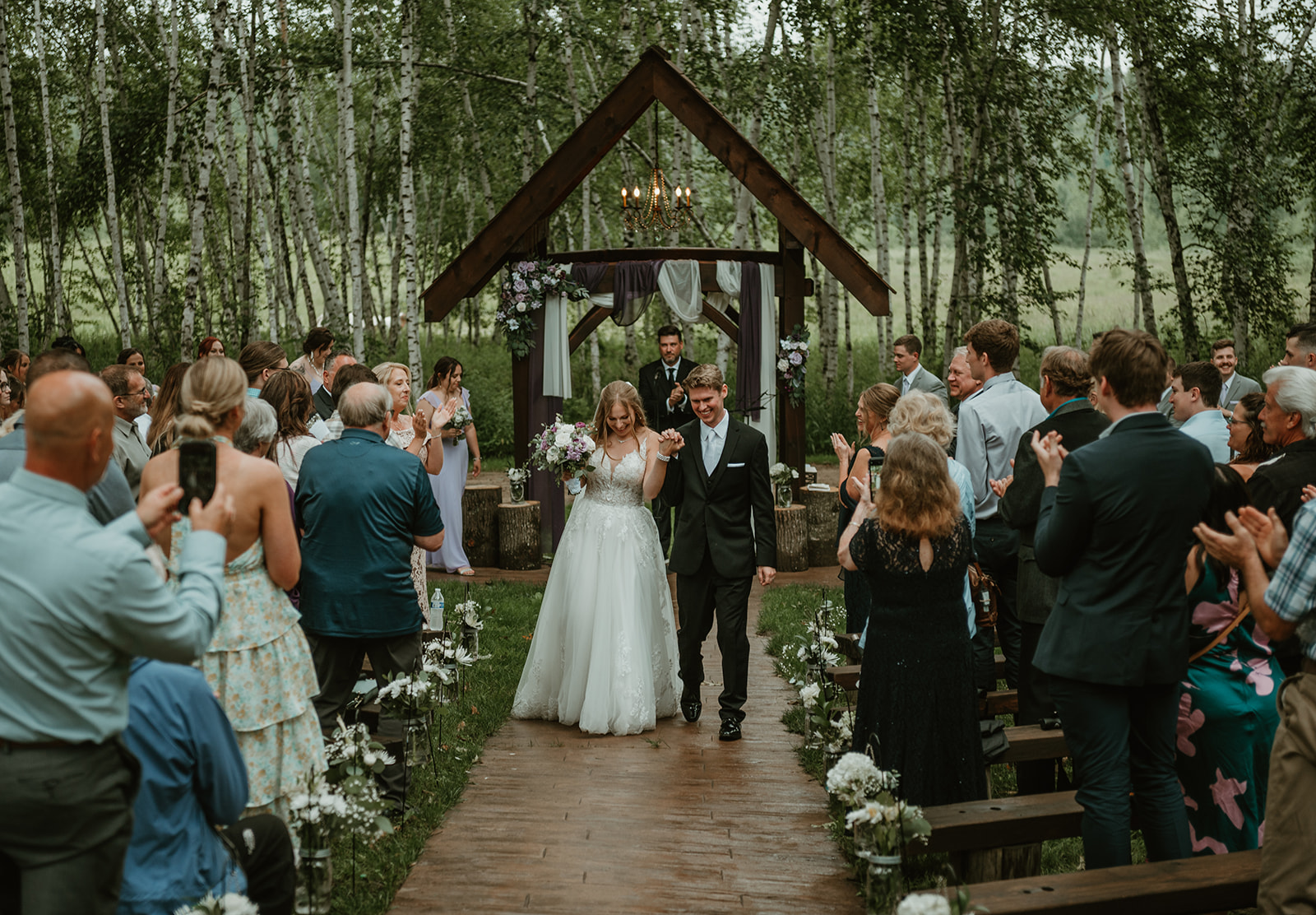 bride and groom walking back up the isle now married