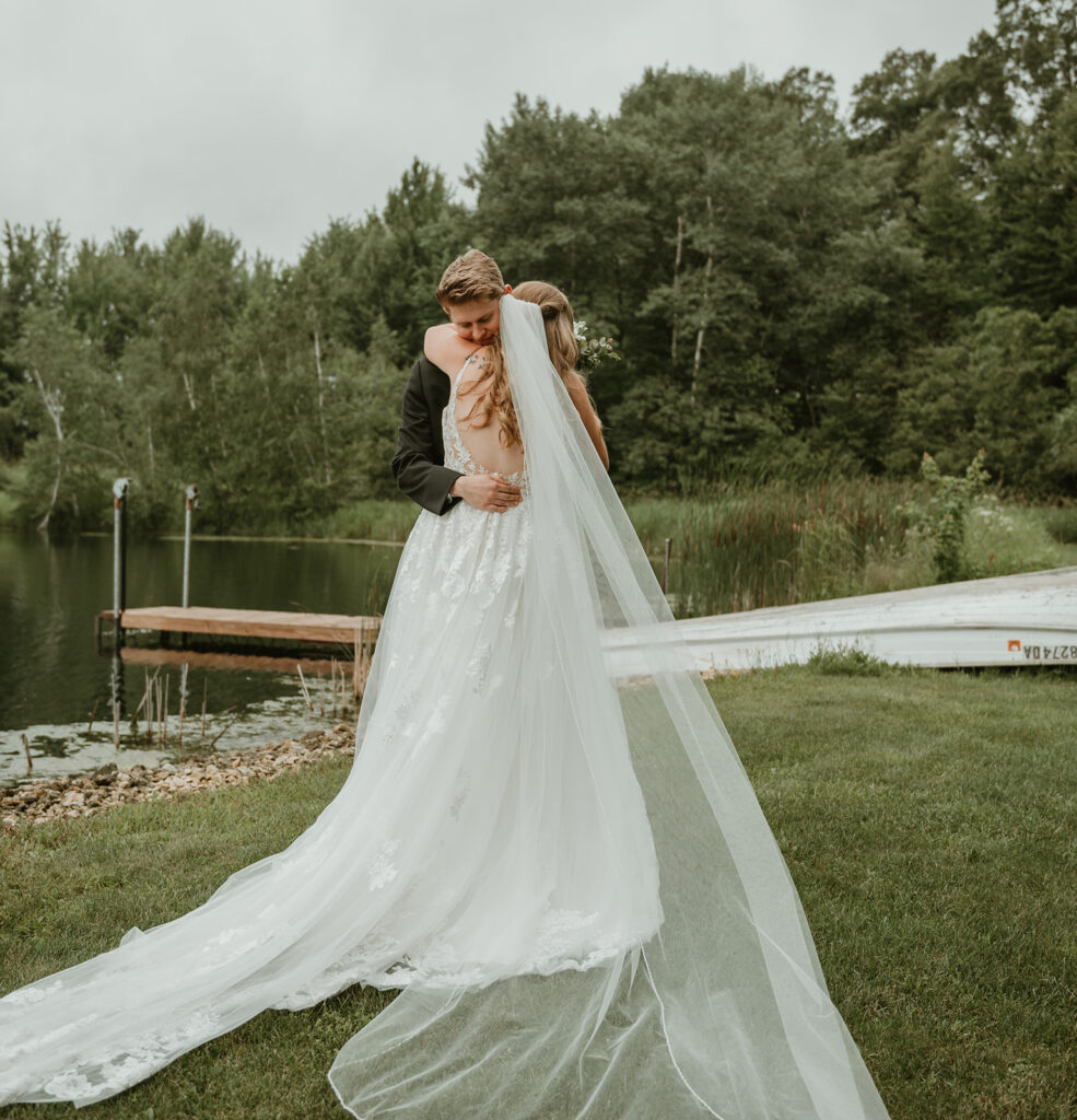 a groom hugging his bride after their first look at dixons apple orchard