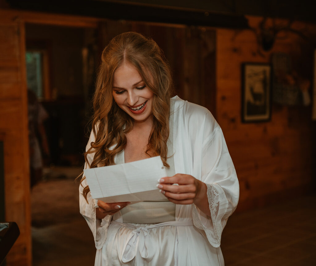 the bride is reading a note from the groom on the morning of the wedding