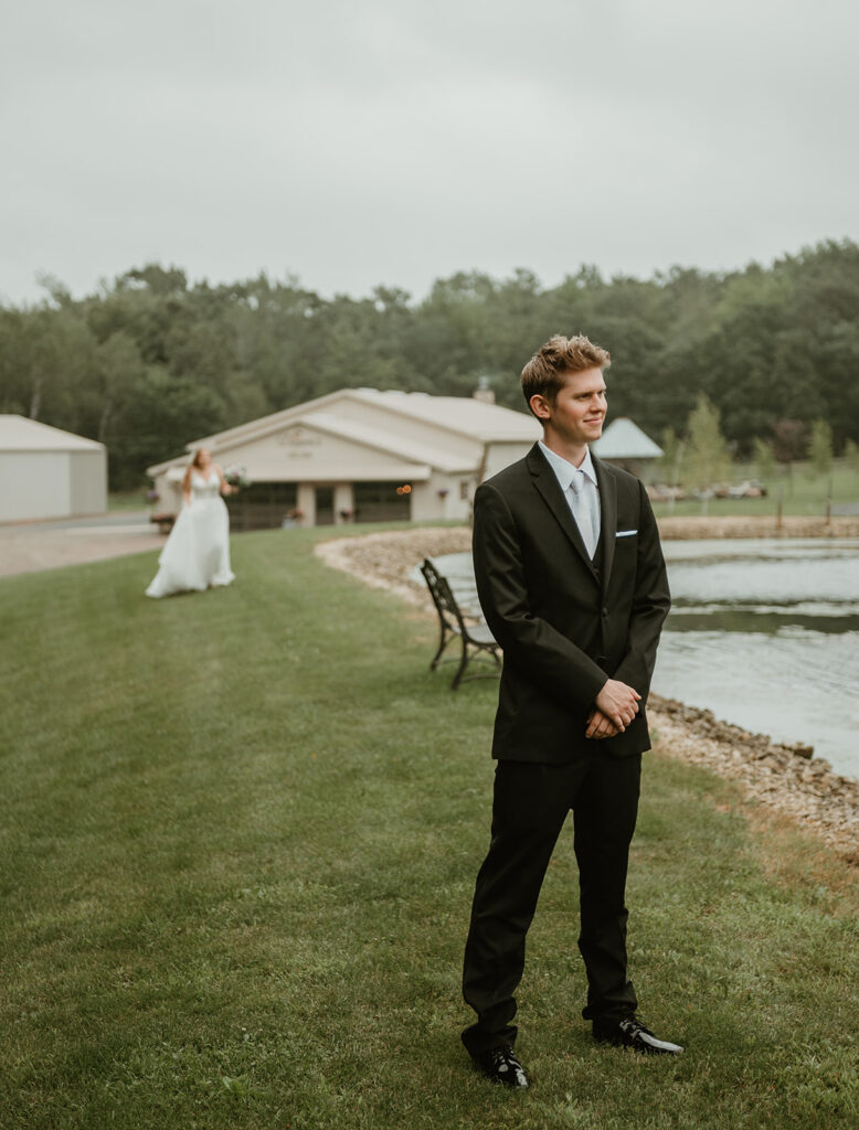 a bride walking up to the groom before the first look at dixons apple orchard