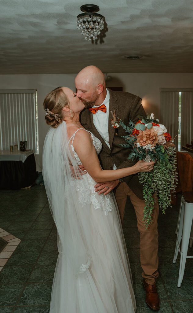 the bride and groom kissing in the bridal suite because they just got married