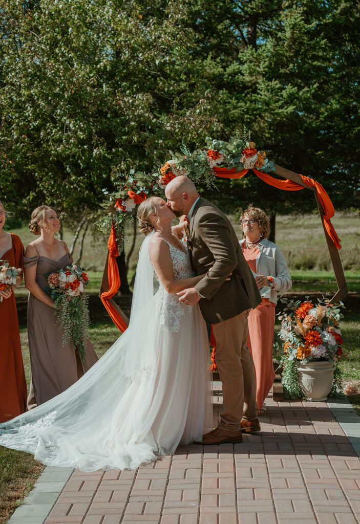 the bride and groom kissing at the altar at homestead meadows 