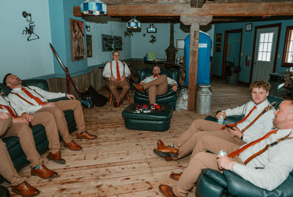 the groom and his groomsmens hanging out in the grooms suite at homestead meadows