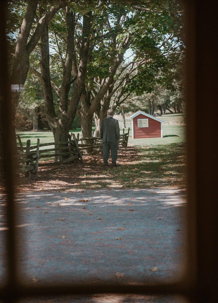 the brides dad is standing outside of the bridal suite at homestead meadows waiting for his daughter to come show him what she looks like in her wedding dress