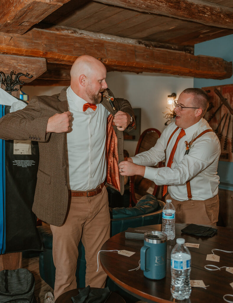 the groom getting ready in the bridal suite at homestead meadows farm for his first look with the bride