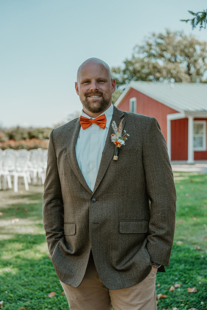 a groom smiling at the camera