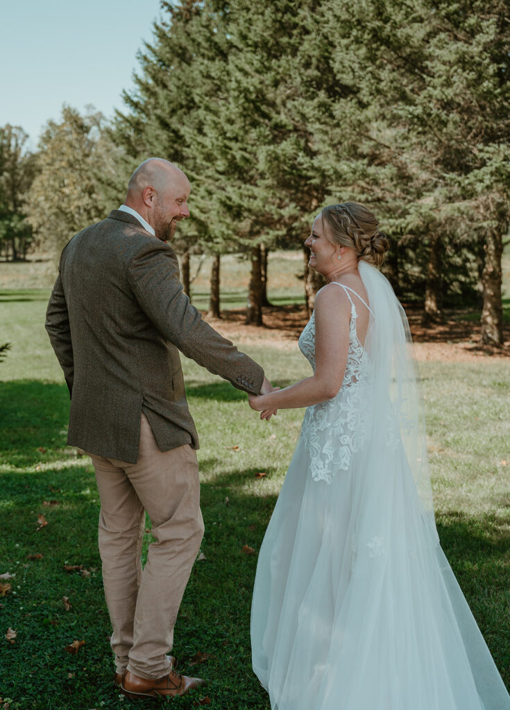 a groom seeing the bride for the first time during their first look 