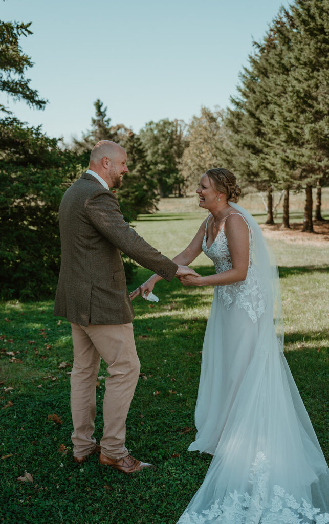 the bride and groom are very excited and happy to see each other during the first look