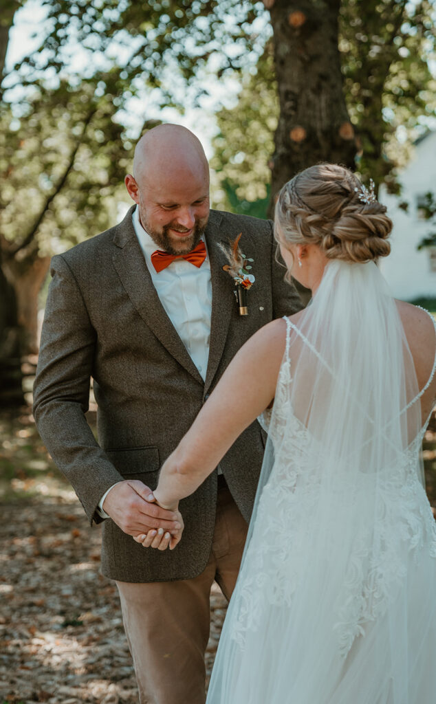 the groom is in awe of his bride and how beautiful she is