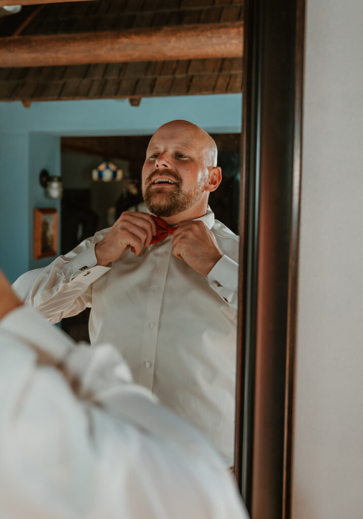 groom getting ready in the grooms suite at homestead meadows farm