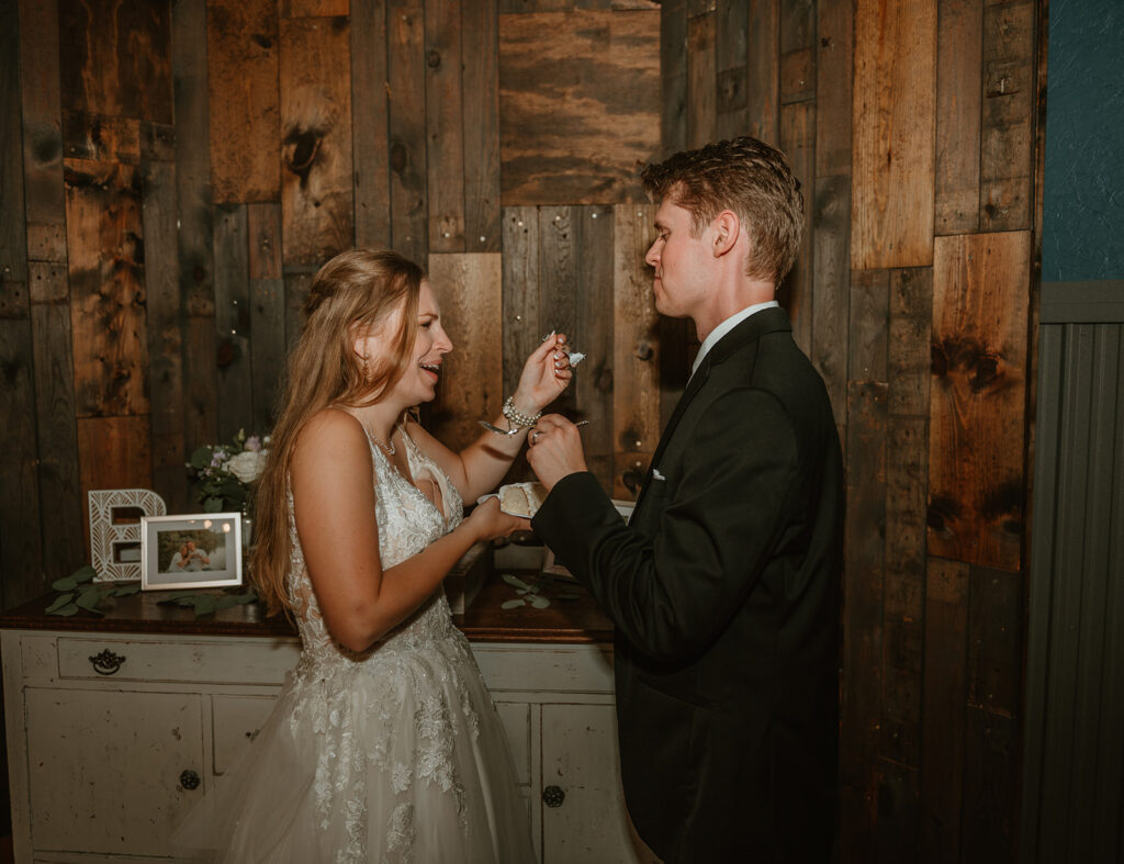 bride and groom trying their wedding cake for the first time