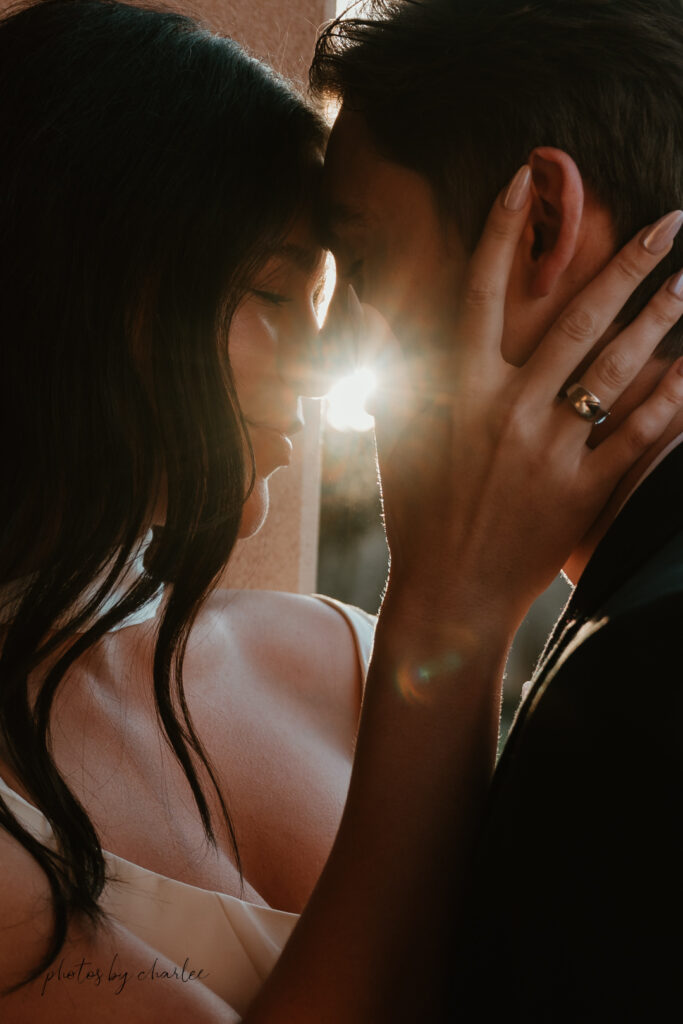 Romantic couple portrait with Spanish-style architecture at Liberty Station, San Diego