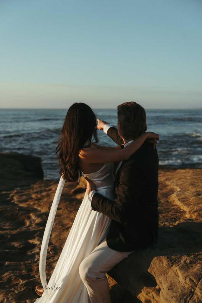 Bride gazes at the Pacific Ocean from a scenic viewpoint at Sunset Cliffs, San Diego elopement inspiration