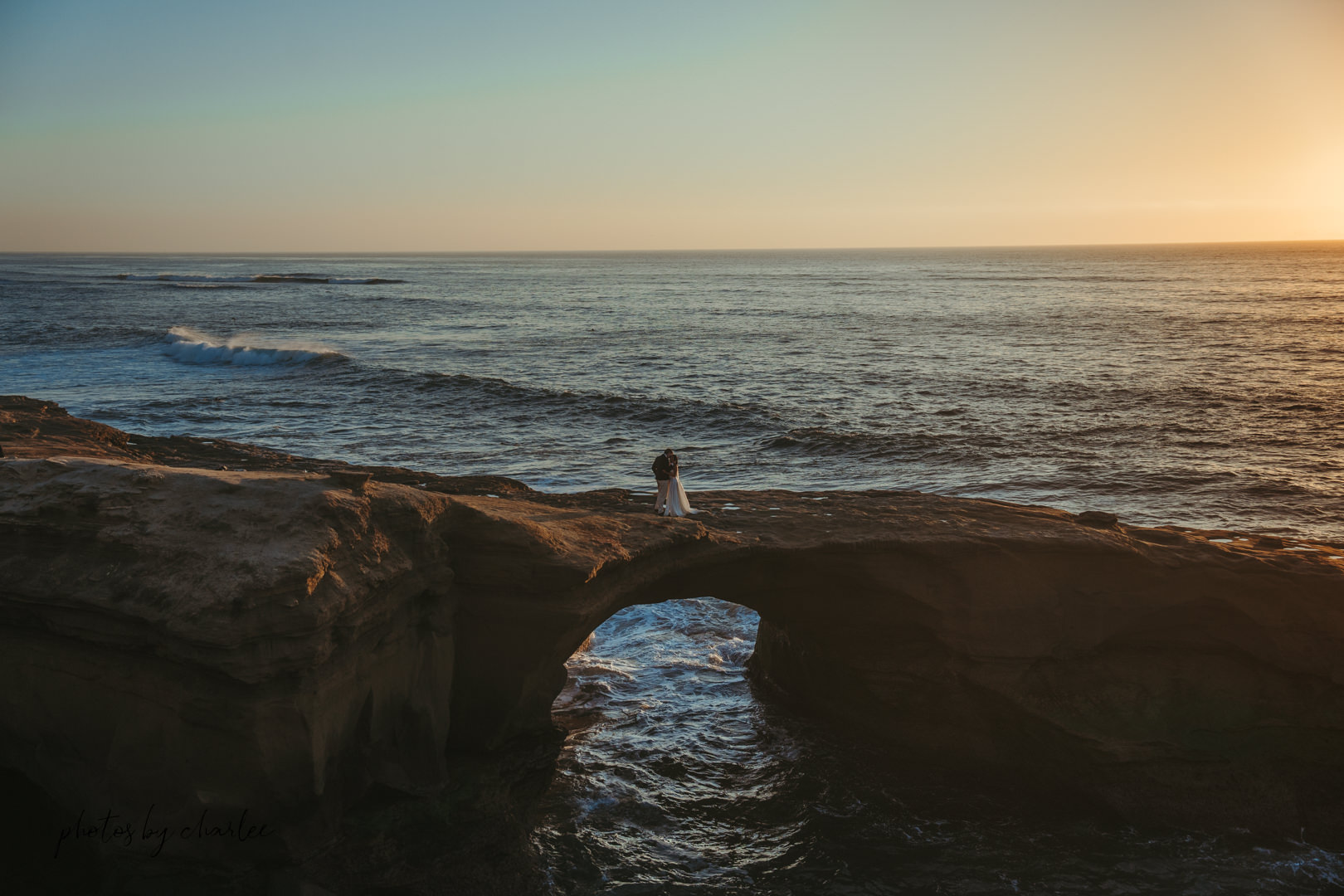 Sweeping panoramic view of Sunset Cliffs sea caves bathed in golden sunset light, San Diego elopement location